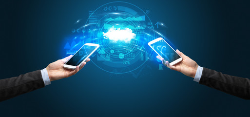 Two mobile phones syncing through the cloud