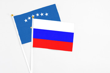 Russia and Kosovo stick flags on white background. High quality fabric, miniature national flag. Peaceful global concept.White floor for copy space.