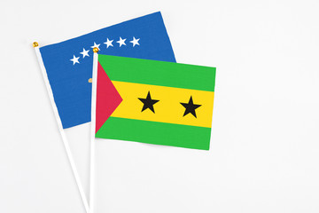 Sao Tome And Principe and Kosovo stick flags on white background. High quality fabric, miniature national flag. Peaceful global concept.White floor for copy space.