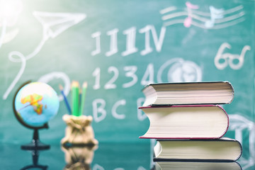 School books on desk, Concept education of teaching and learning materials in high school, college or university campus. Selective focus