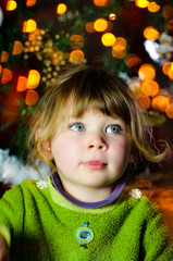pretty little girl in front admiring Christmas decoration