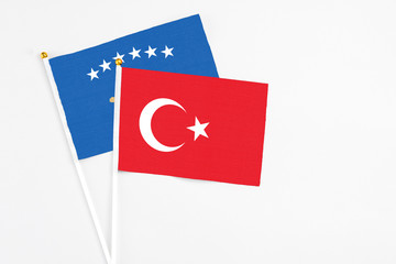Turkey and Kosovo stick flags on white background. High quality fabric, miniature national flag. Peaceful global concept.White floor for copy space.