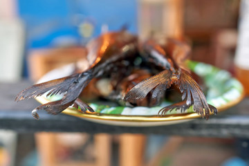 Appetizing smoked fish on a plate close-up