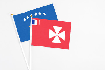 Wallis And Futuna and Kosovo stick flags on white background. High quality fabric, miniature...
