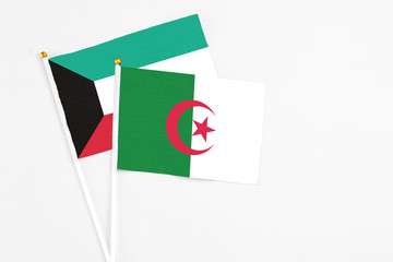Algeria and Kuwait stick flags on white background. High quality fabric, miniature national flag....