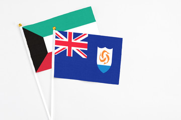 Anguilla and Kuwait stick flags on white background. High quality fabric, miniature national flag. Peaceful global concept.White floor for copy space.