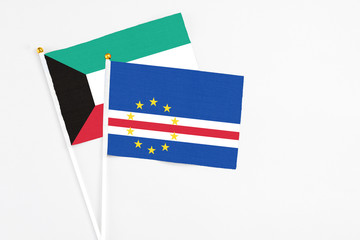 Cape Verde and Kuwait stick flags on white background. High quality fabric, miniature national flag. Peaceful global concept.White floor for copy space.