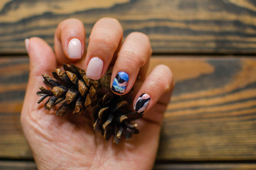 Women's hands with colorful pattern on the nails. Top view. Place for text. cozy winter style.