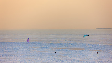 people skiing with a parachute