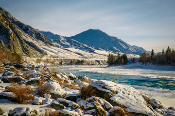 Winter in the mountains, unfrozen river, frost and sun, wonderful day. Journey through the wild places, new year and Christmas holidays in the mountains.