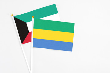 Gabon and Kuwait stick flags on white background. High quality fabric, miniature national flag....