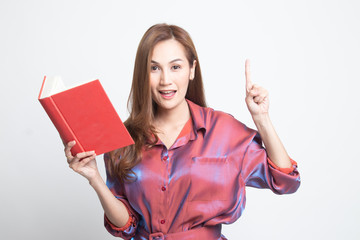 Young Asian woman with a book have an idea.
