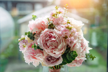 Lush bridal bouquet of pale pink flowers, close-up, blurred background. Wedding concept, postcard.