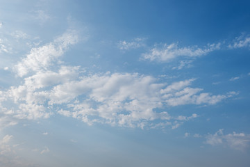 Naklejka na ściany i meble abstract background of white fluffy clouds on a bright blue sky on a sunny day
