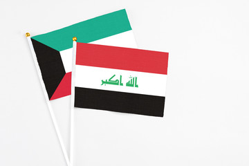 Iraq and Kuwait stick flags on white background. High quality fabric, miniature national flag. Peaceful global concept.White floor for copy space.