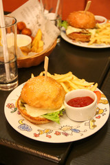 Hamburger and fries on a kid's plate.