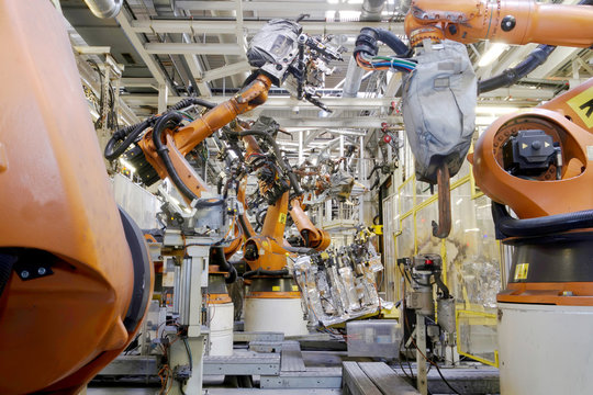 welding robots in car assembly manufacturing hall