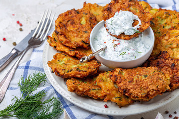 Delicious zucchini fritters with yogurt sauce.