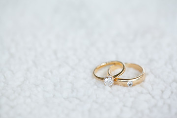 Diamond wedding rings on white soft wool