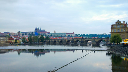 Vltava river flowing through Prague with Charles Bridge (Karlův most) at the background (Czech Republic)