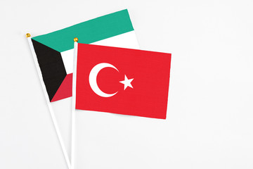 Turkey and Kuwait stick flags on white background. High quality fabric, miniature national flag. Peaceful global concept.White floor for copy space.