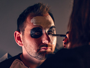 Female make up artist painting face