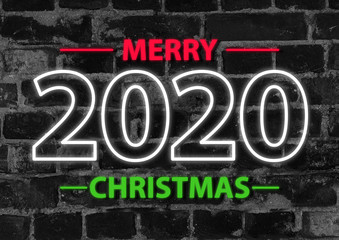 2020 in neon multi colour design, parallel lines pattern on black brick background. Holidays, celebrating night, New Year and Christmas event, bright colors. Copyspace, advertising.