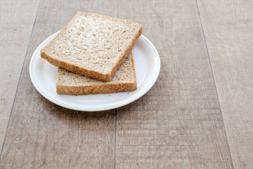 Fototapeta na wymiar Fresh and nutritious whole wheat bread on wooden background