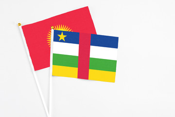 Central African Republic and Kyrgyzstan stick flags on white background. High quality fabric, miniature national flag. Peaceful global concept.White floor for copy space.