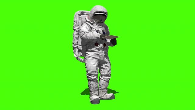 Astronaut on the moon typing on a laptop with a green screen.