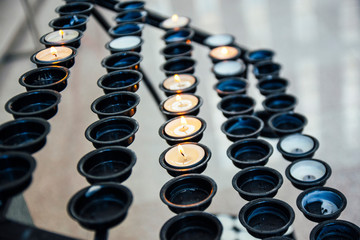 Burning candles in a church close-up