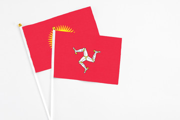 Isle Of Man and Kyrgyzstan stick flags on white background. High quality fabric, miniature national...