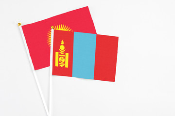 Mongolia and Kyrgyzstan stick flags on white background. High quality fabric, miniature national flag. Peaceful global concept.White floor for copy space.