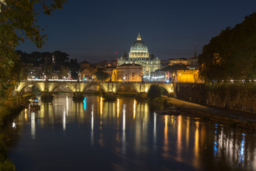 Dusk at the Vatican City. St. Peter's basilica in Rome, Vatican, the dome at sunset with reflection. Night view at St. Peter's cathedral in Rome, Italy. Scenic background. Popular travel destination.