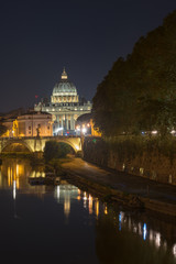 Fototapeta premium Dusk at the Vatican City. St. Peter's basilica in Rome, Vatican, the dome at sunset with reflection. Night view at St. Peter's cathedral in Rome, Italy. Scenic background. Popular travel destination.