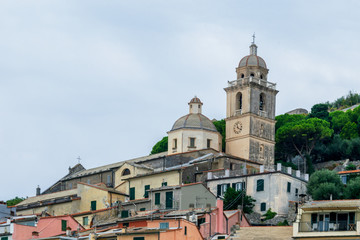 Fototapeta na wymiar The Church of San Lorenzo and colorful buildings from Porto Venere, La Spezia, Italy