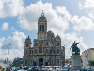 view of Saint Paul church and battle monument statue in Granville in Normandy