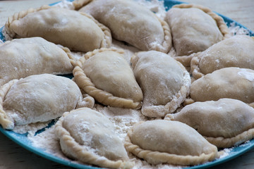 Typical Eastern European food (Ukrainian, Russian, Polish), called Varenyky, Vareniki, Vareneke, Pyrohy or Pierogi.  The process of cooking traditional vareniki - textured background