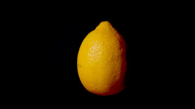 Close up of half citron spinning around,black background,close up