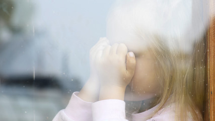 Girl crying outside the window in an old house. Child psychologist. Psychology of growing up and...