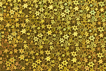 Background from holographic wrapping paper. Selective focus. Christmas background.