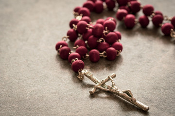 Catholic rosary on the stone background