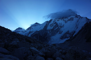 Everest base camp trek along Khumbu glacier, First sun rays from behind Nuptse in Himalayas mountains, Sagarmatha national park, Solukhumbu, Nepal