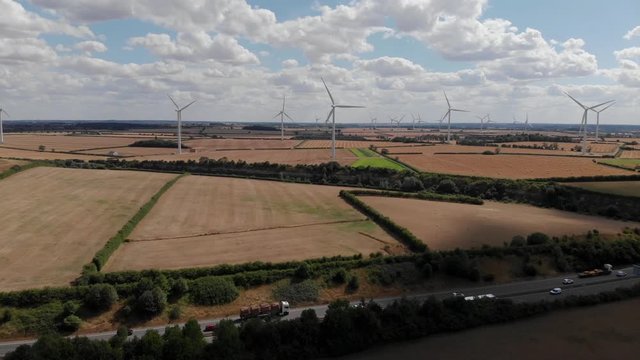 Aerial View Of Wind Farm And A14 Road Cloudy Blue Sky