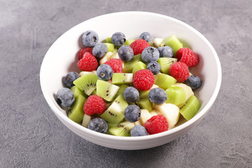 bowl of fresh fruit salad with berry, banana and kiwi- healthy eating