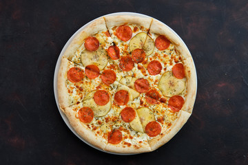 Top view of pizza with sausage, pear and dor blue cheese