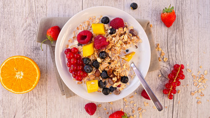 bowl of muesli, milk and fruits