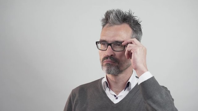 portrait of stubble bearded man looking at camera thinking