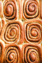 Fresh homemade cinnabons with cinnamon isolate. Homemade baking.