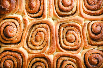 Fresh homemade cinnabons with cinnamon isolate. Homemade baking.